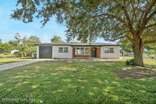 ranch-style home with a front yard and a garage