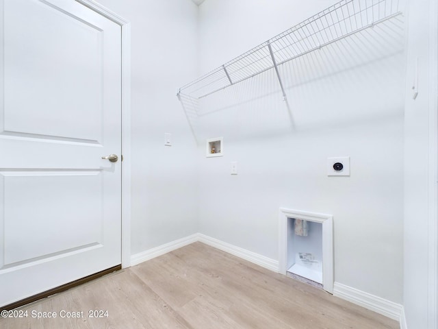 washroom with light wood-type flooring, hookup for an electric dryer, and hookup for a washing machine