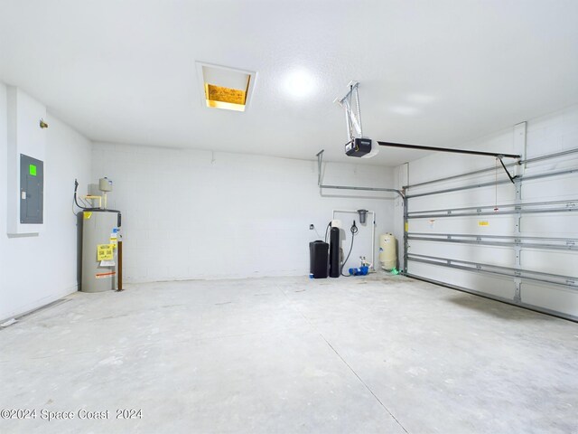 3143 Fullerton Ave SW, Palm Bay, FL 32908 - garage with water heater, electric panel, and a garage door opener