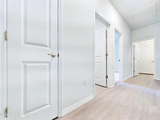 hallway with light hardwood / wood-style floors