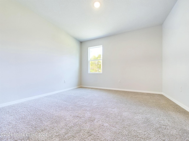 3143 Fullerton Ave SW, Palm Bay, FL 32908 - unfurnished room featuring carpet, baseboards, and lofted ceiling