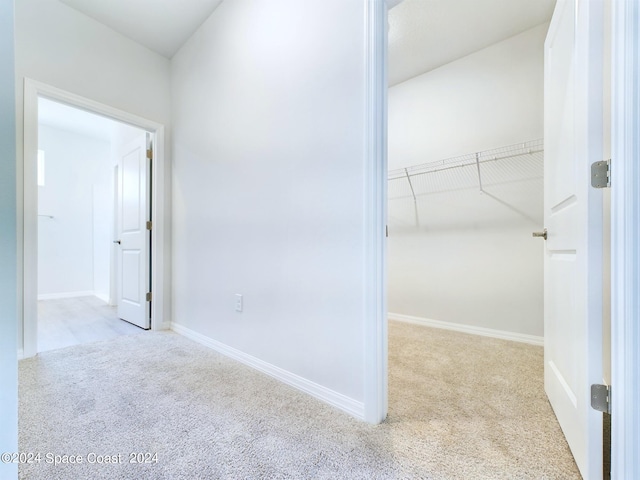 hallway with light colored carpet