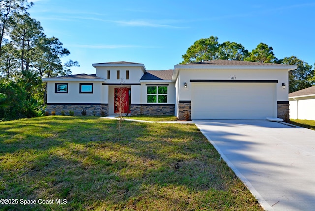 view of front facade with a front yard and a garage