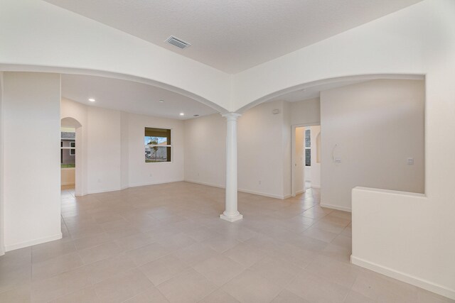 spare room with decorative columns