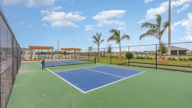 view of tennis court featuring a pergola