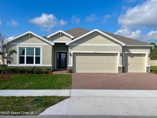 view of front of property with a garage and a front yard