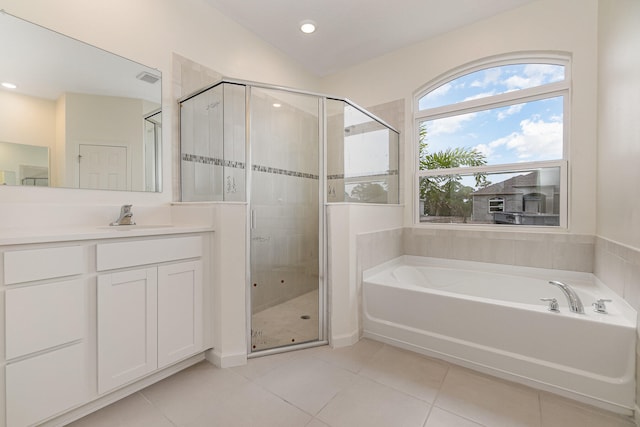 bathroom with vaulted ceiling, vanity, shower with separate bathtub, and tile patterned flooring