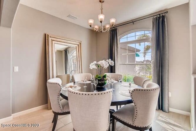 dining area featuring a chandelier and light hardwood / wood-style floors