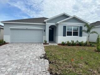 view of front facade with a garage and a front lawn