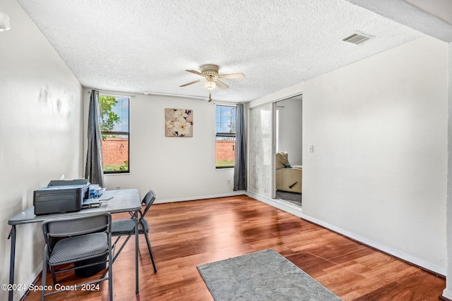 office featuring ceiling fan, a textured ceiling, and hardwood / wood-style floors