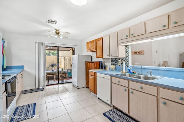 kitchen with sink, decorative backsplash, white appliances, light tile patterned floors, and ceiling fan