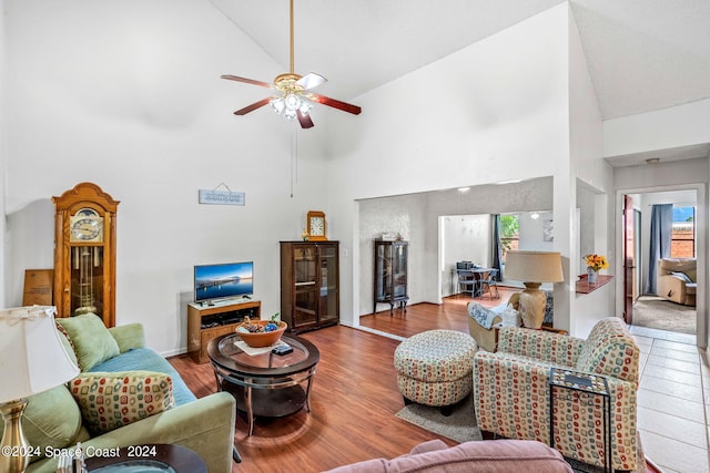 living room featuring high vaulted ceiling, ceiling fan, and hardwood / wood-style floors