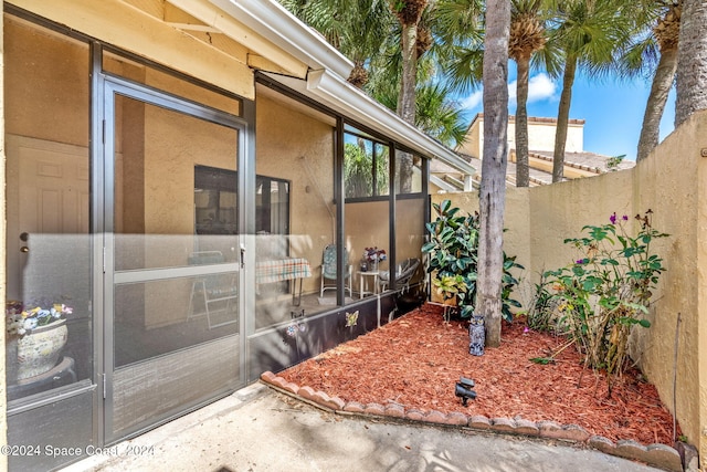 view of property exterior with a sunroom