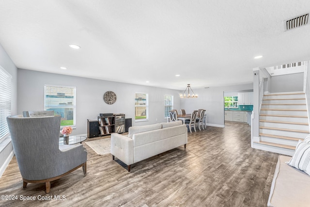 living area with recessed lighting, stairs, wood finished floors, and visible vents