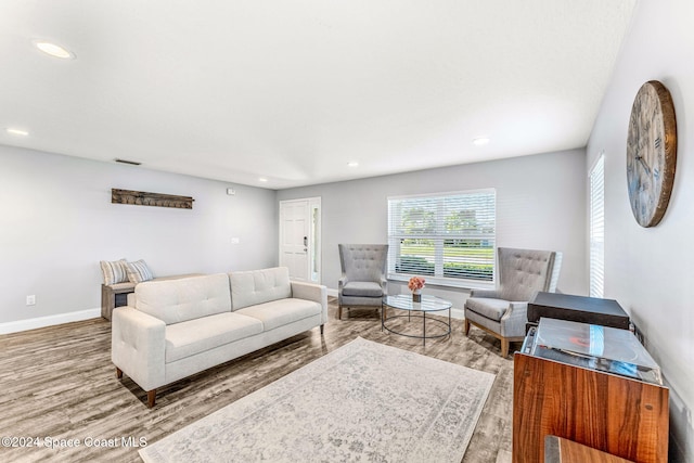 living room featuring recessed lighting, baseboards, and wood finished floors