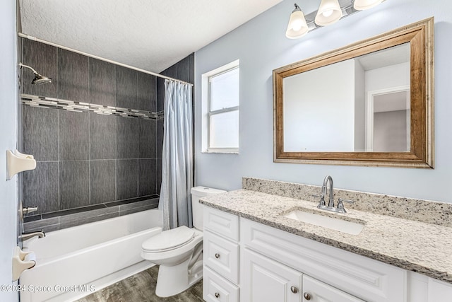 full bathroom featuring wood-type flooring, a textured ceiling, toilet, vanity, and shower / tub combo with curtain