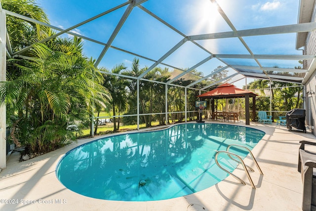 view of swimming pool featuring a gazebo, a lanai, a patio, and a grill