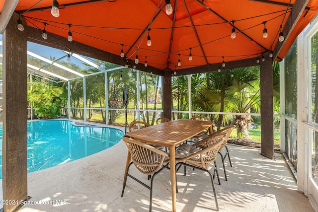 view of swimming pool with a patio area and a lanai