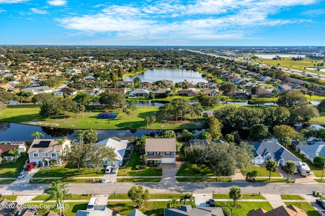bird's eye view featuring a water view and a residential view