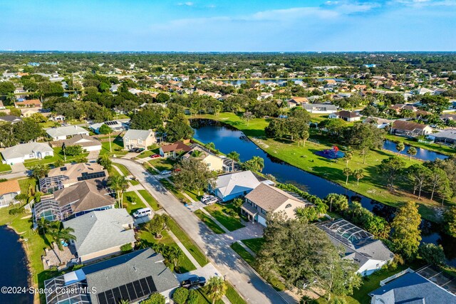 bird's eye view featuring a water view and a residential view