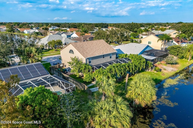 drone / aerial view featuring a residential view and a water view