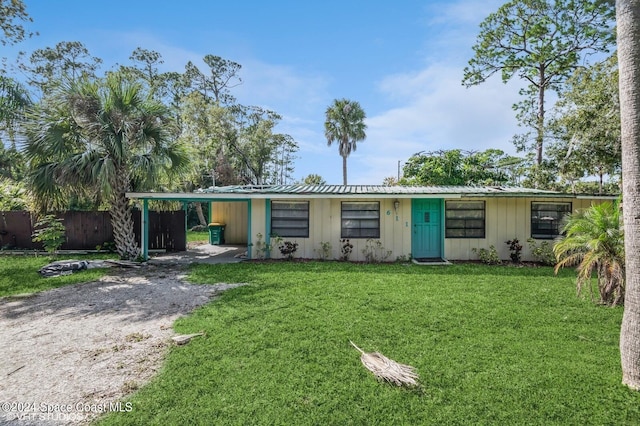 ranch-style home with a front yard and a carport