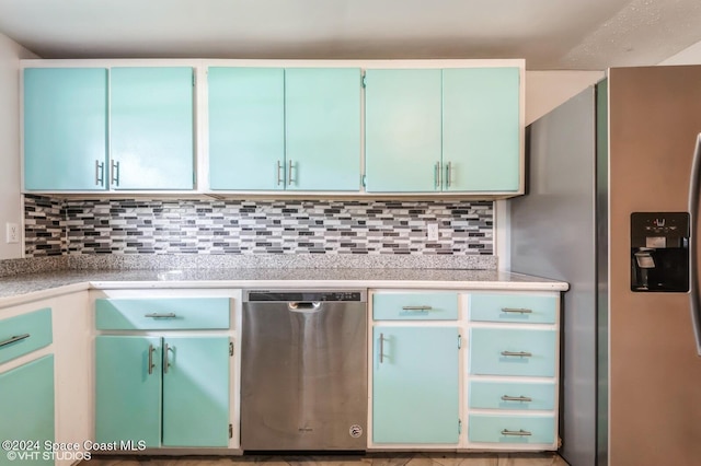 kitchen featuring stainless steel appliances and tasteful backsplash