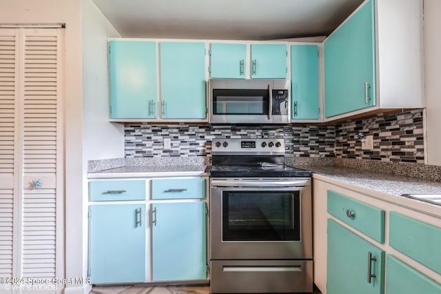 kitchen featuring stainless steel appliances and tasteful backsplash