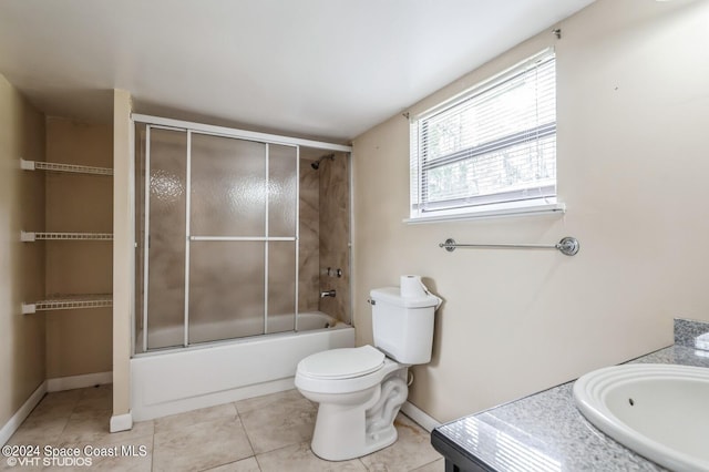 full bathroom featuring toilet, vanity, shower / bath combination with glass door, and tile patterned flooring