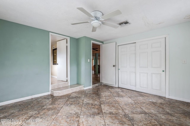 unfurnished bedroom with a closet, a textured ceiling, and ceiling fan