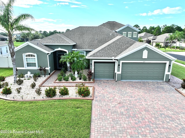 view of front of home with a front lawn and a garage