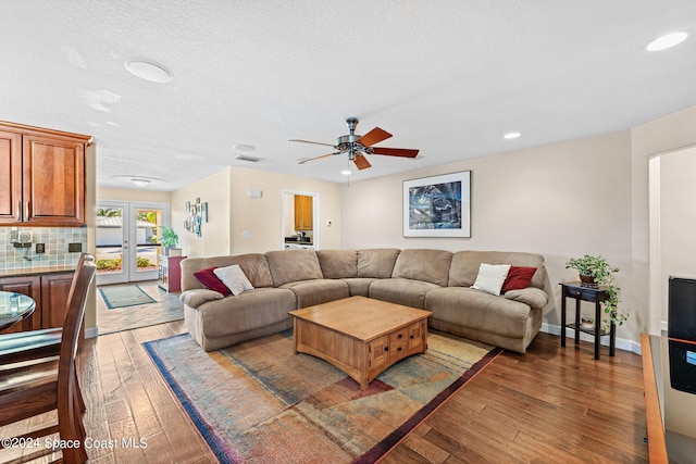 living room with french doors, a textured ceiling, hardwood / wood-style floors, and ceiling fan