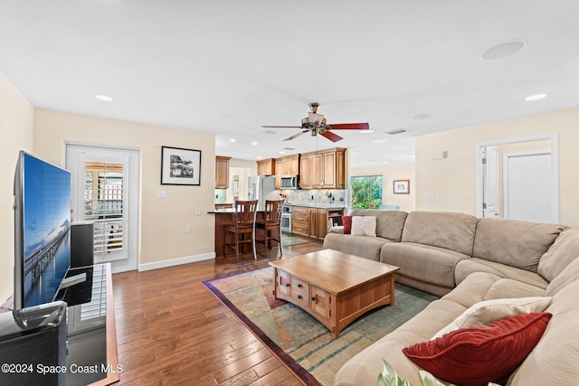 living room featuring plenty of natural light, hardwood / wood-style floors, and ceiling fan