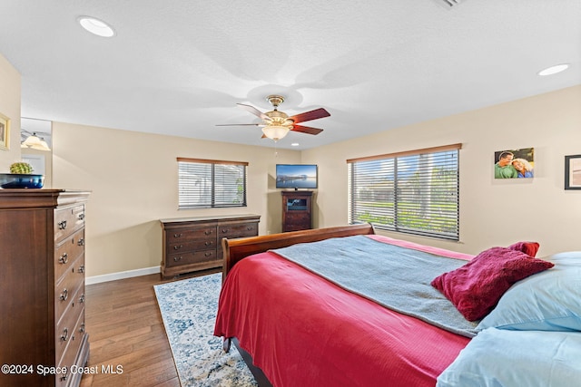 bedroom with ceiling fan and hardwood / wood-style floors