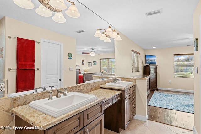 bathroom with vanity, hardwood / wood-style flooring, plenty of natural light, and ceiling fan