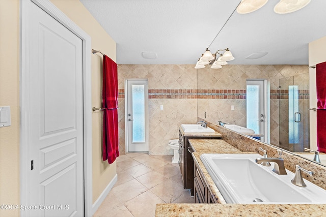 bathroom featuring vanity, toilet, a textured ceiling, walk in shower, and tile patterned flooring