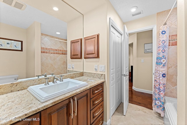 full bathroom with vanity, shower / tub combo, toilet, and wood-type flooring