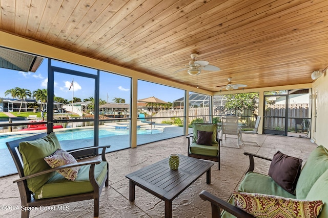 sunroom / solarium with wood ceiling and ceiling fan