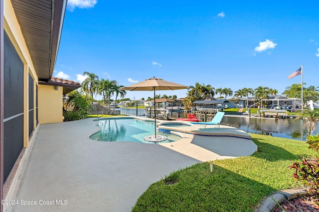 view of swimming pool with a water view, an in ground hot tub, a patio, and a lawn