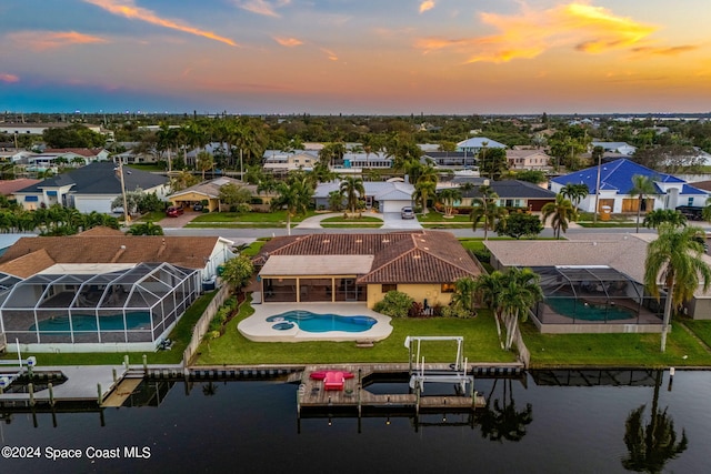 aerial view at dusk with a water view