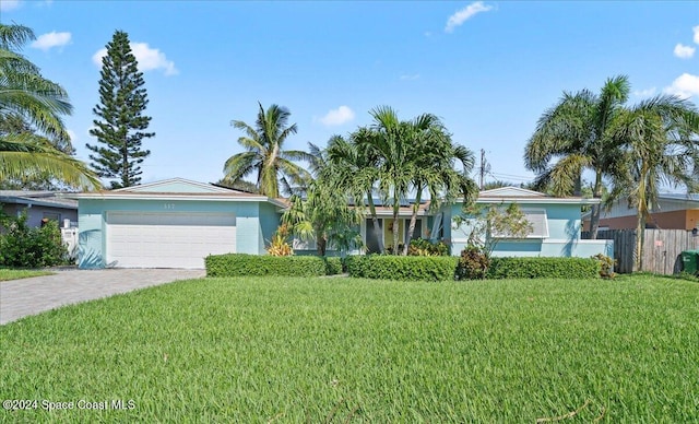 single story home featuring a garage and a front lawn