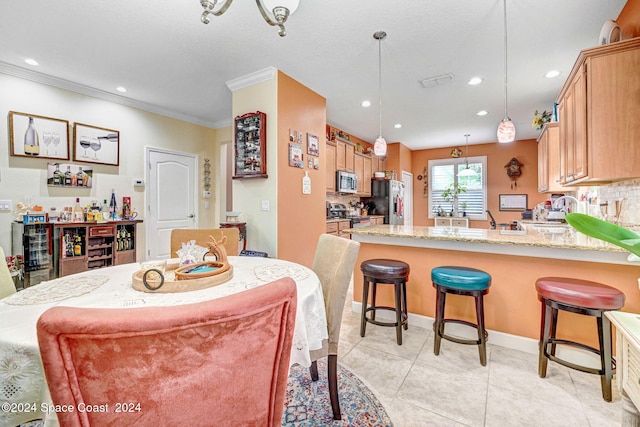 dining area featuring light tile patterned floors, ornamental molding, baseboards, and recessed lighting