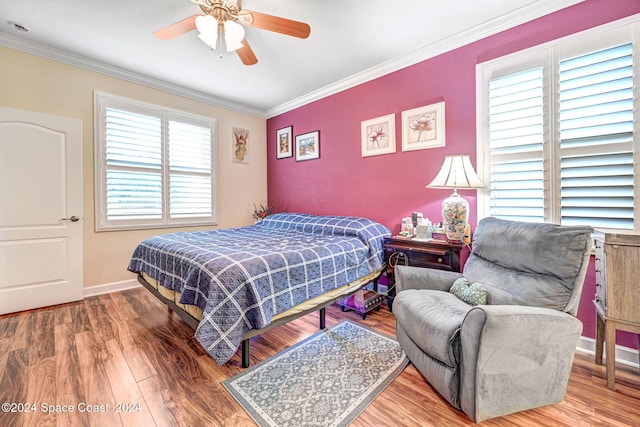 bedroom featuring ornamental molding, ceiling fan, and wood-type flooring