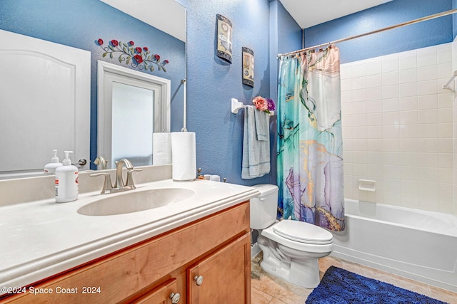 full bath featuring a textured wall, toilet, shower / bath combo, vanity, and tile patterned floors