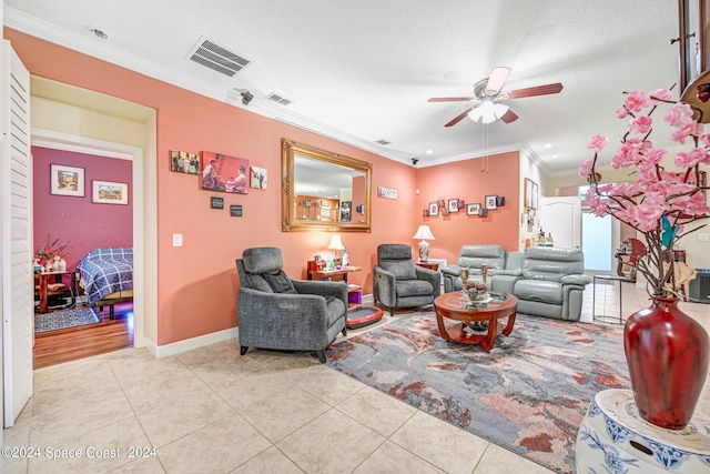 tiled living room with ornamental molding and ceiling fan