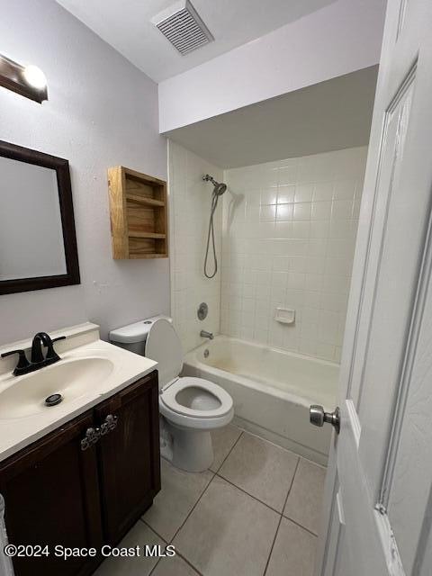 full bathroom featuring toilet, tile patterned flooring, vanity, and tiled shower / bath