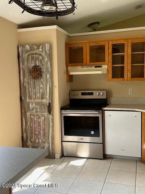 kitchen with a textured ceiling, lofted ceiling, stainless steel electric range oven, and light tile patterned floors