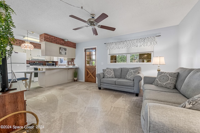 carpeted living room featuring a textured ceiling and ceiling fan