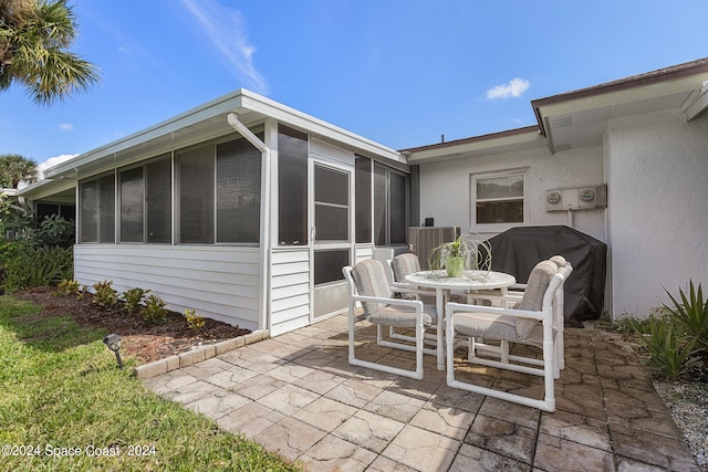 view of patio / terrace with grilling area and a sunroom