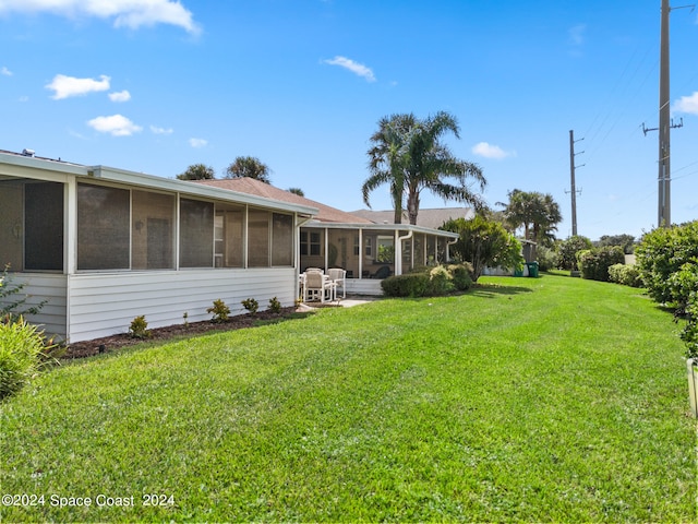 view of yard featuring a sunroom